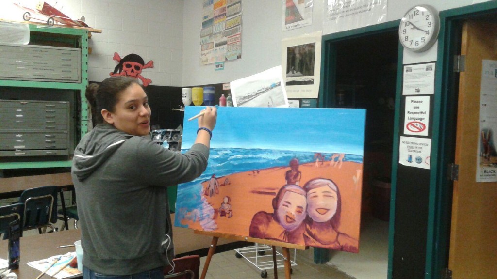  Guadalupe Correa of Royal Palm Beach High School works on a beach scene with portraits.